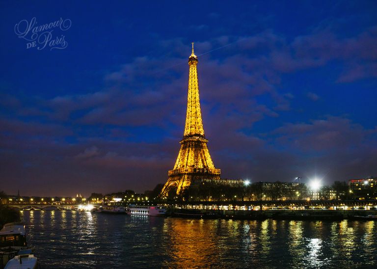 Eiffel Tower at night reflecting on the Seine River