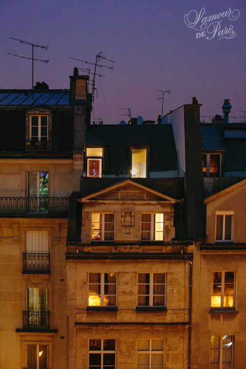 Romantic photo of glowing windows during sunset in Paris