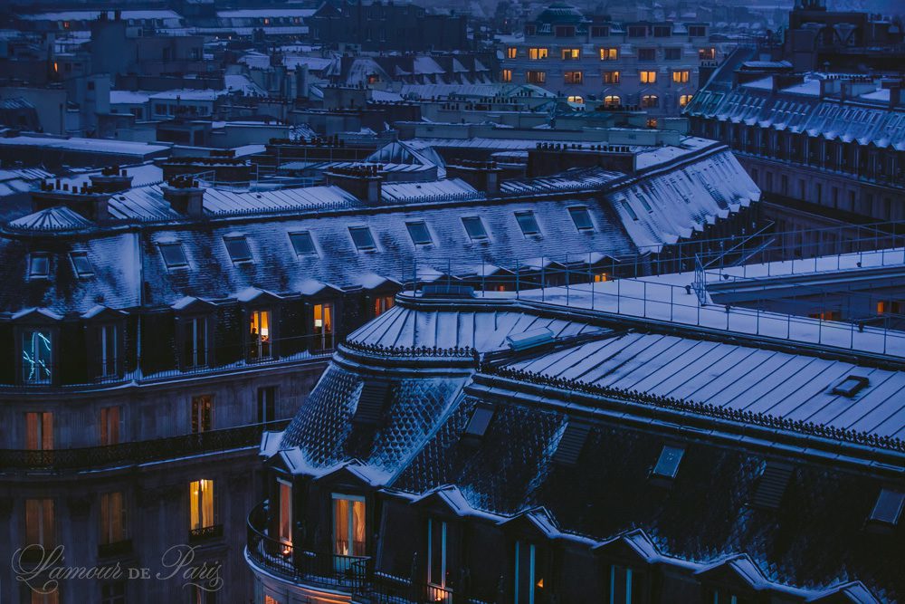 Snow covered rooftops of Paris photographed from the Galeries Lafayette terrace at night photographed by Stacy Reeves by Paris travel planning and photography blog L'Amour de Paris