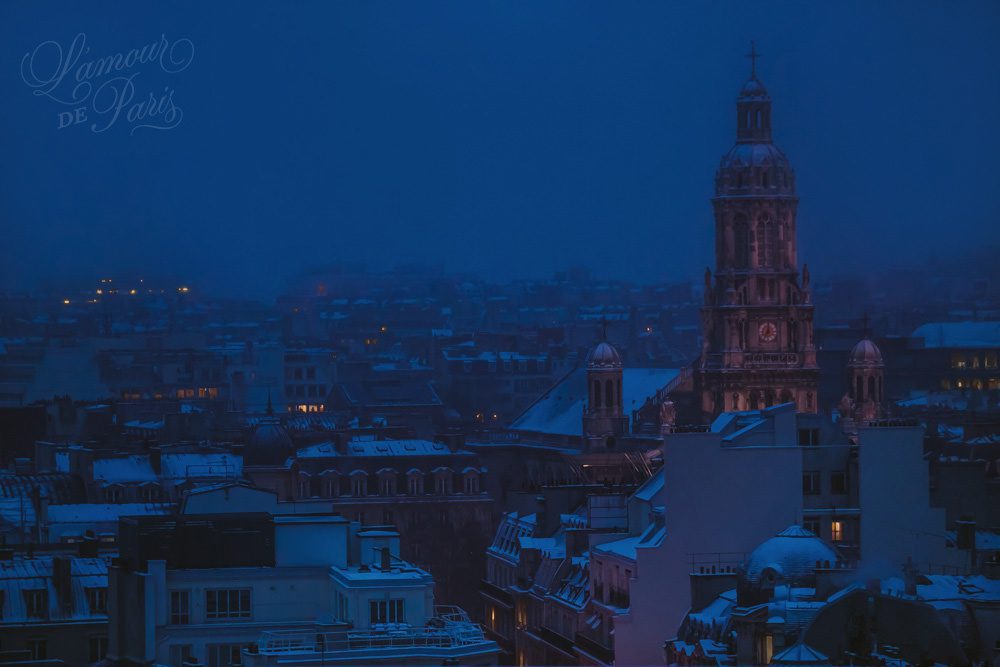Snow covered rooftops of Paris photographed from the Galeries Lafayette terrace at night photographed by Stacy Reeves by Paris travel planning and photography blog L'Amour de Paris