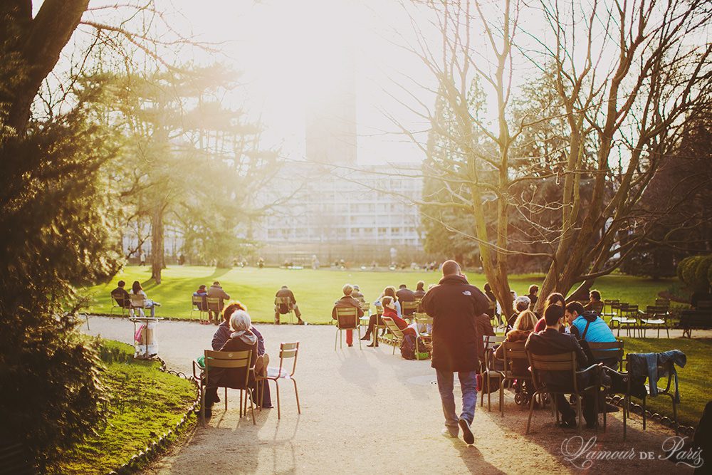 Parisians relaxing on a spring day at sunset in the Jardin du Luxembourg