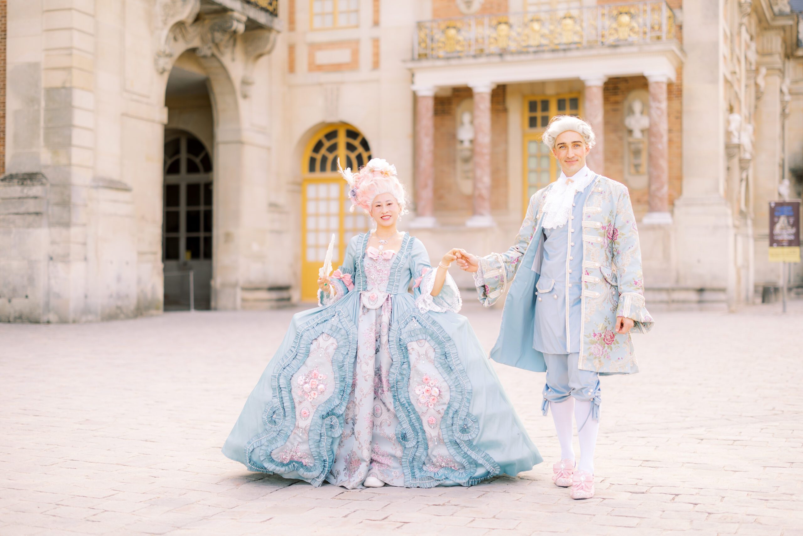 a couple in costume at the 2025 versailles masquerade ball