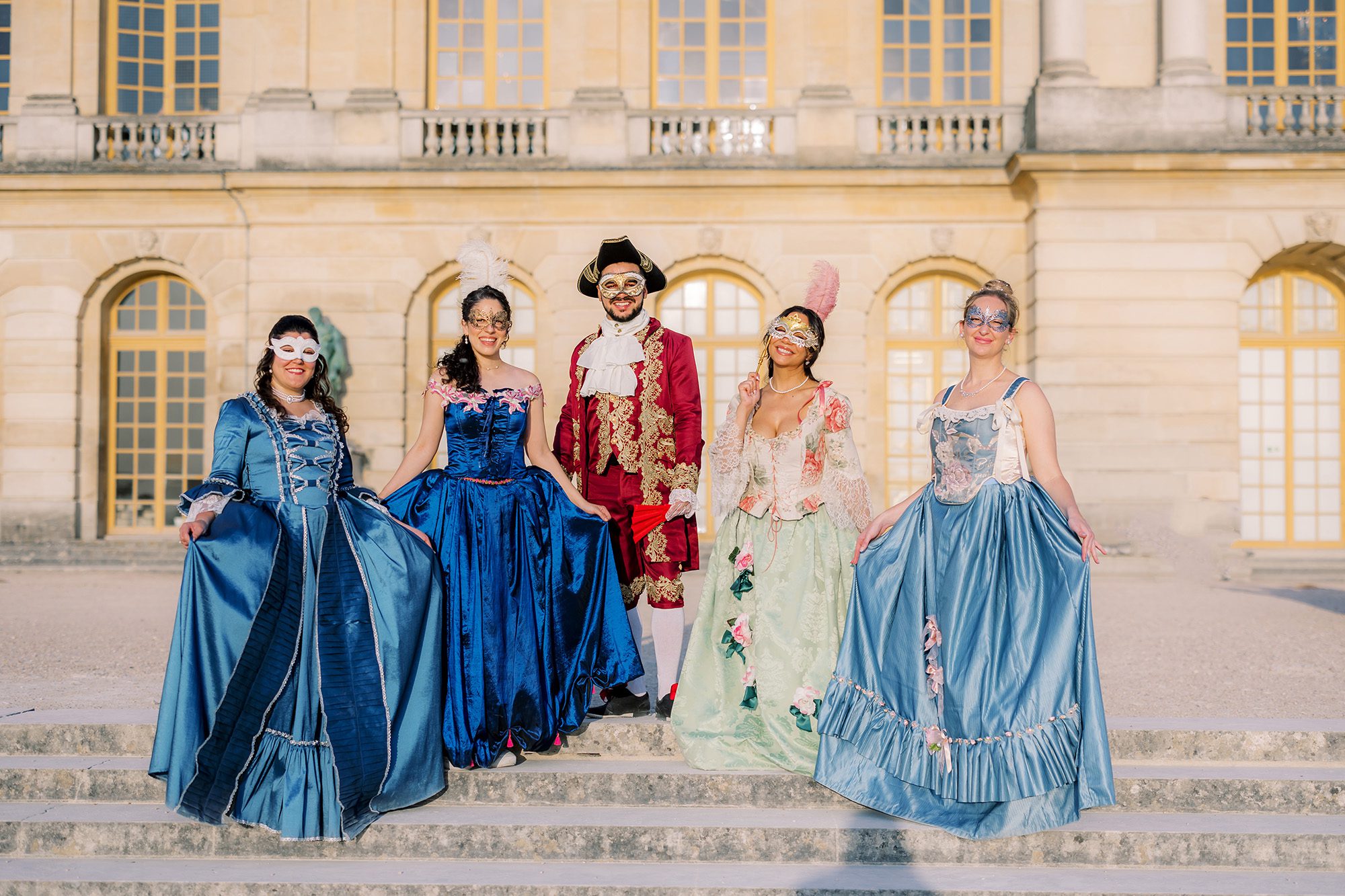 a group portrait in costume at the 2025 versailles masquerade ball