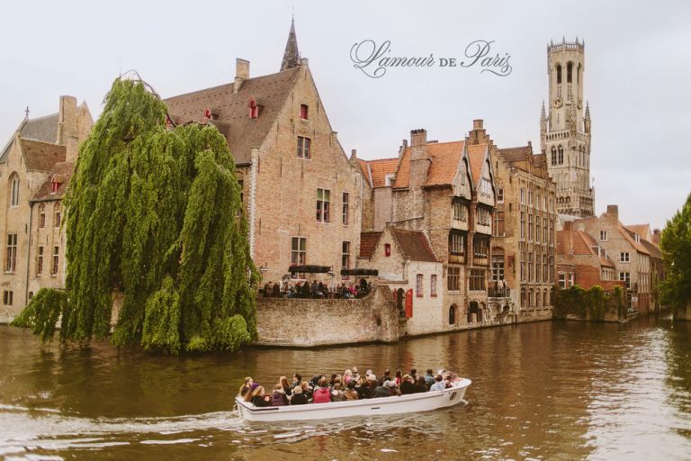 Tourist sightseeing boats on the canals in Brugge or Bruges, Belgium