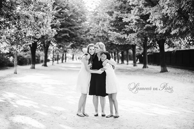 Family portrait session in front of the Eiffel Tower by Paris wedding photographer Stacy Reeves for travel planning blog L'Amour de Paris
