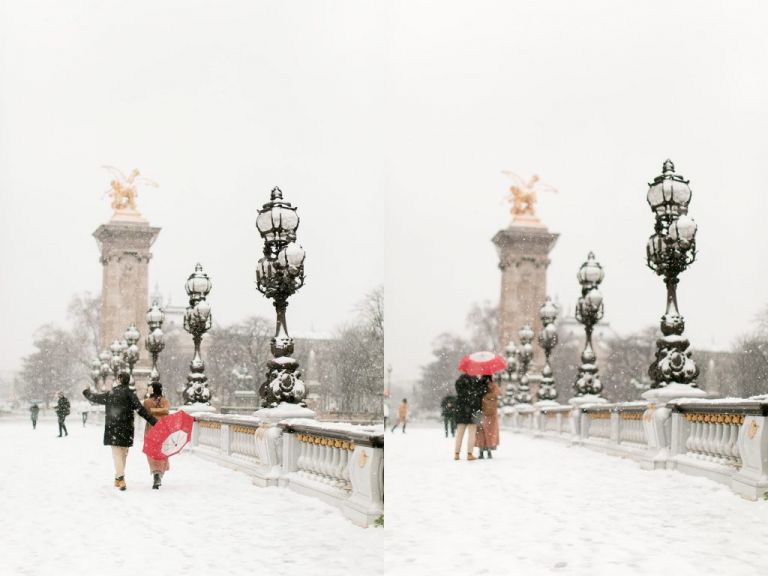 snow in paris at pont alexandre with couple with red umbrella