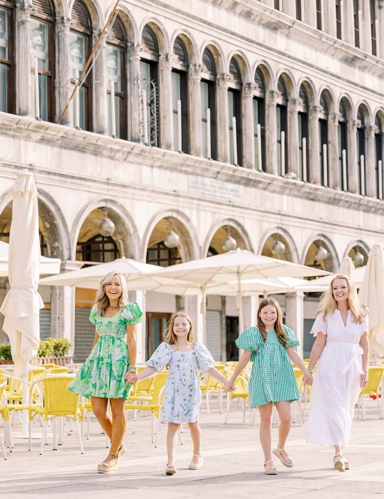 Mother with her two daughters and grandmother walking in venice