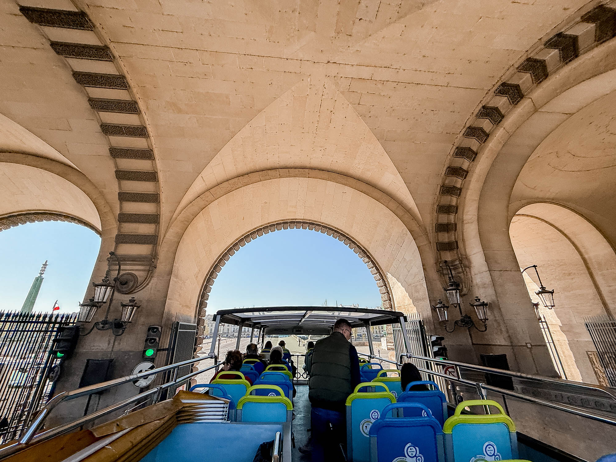 archways of the louvre seen from paris hop on hop off bus tour