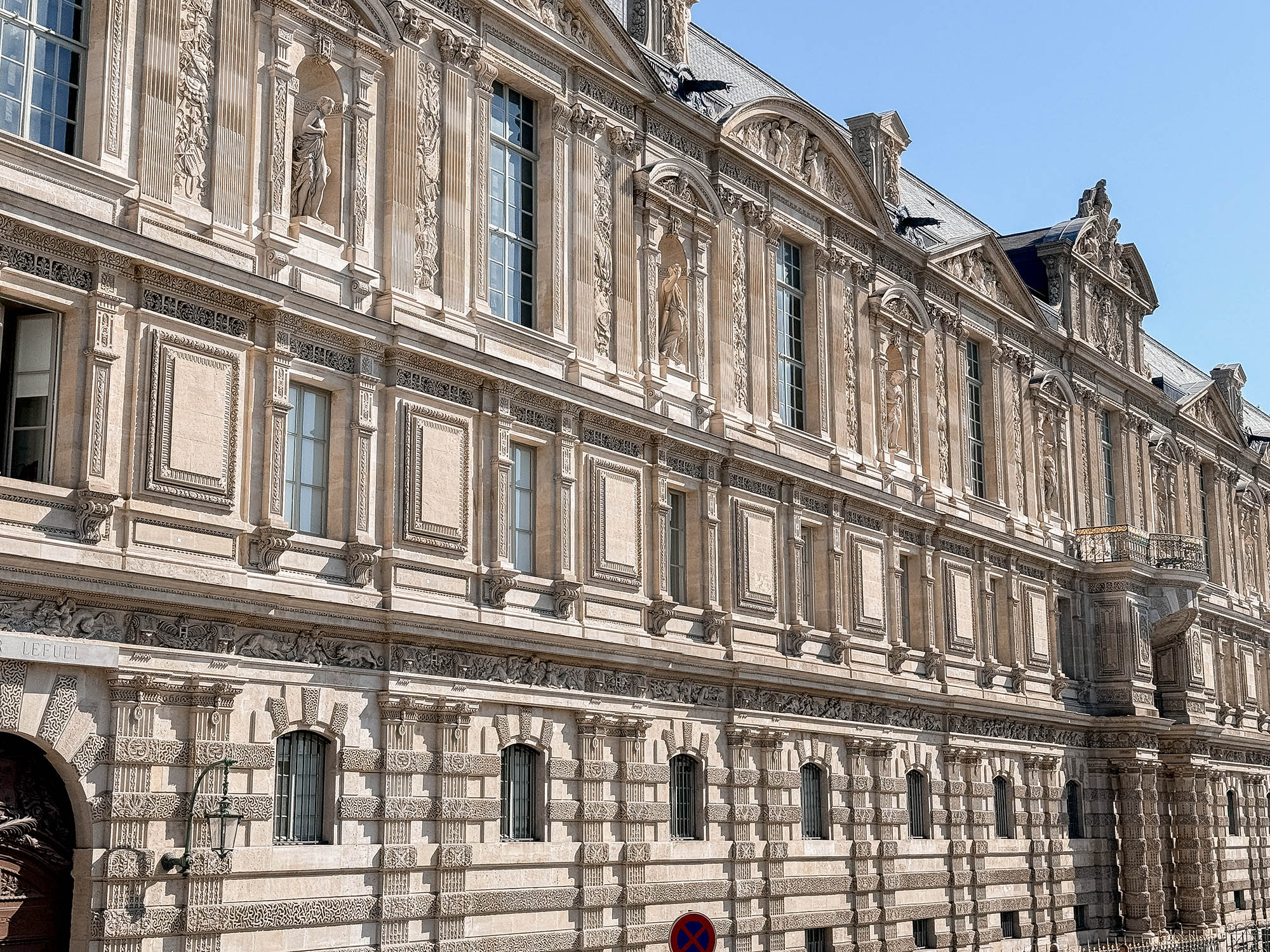 side of the louvre seen from paris hop on hop off bus tour