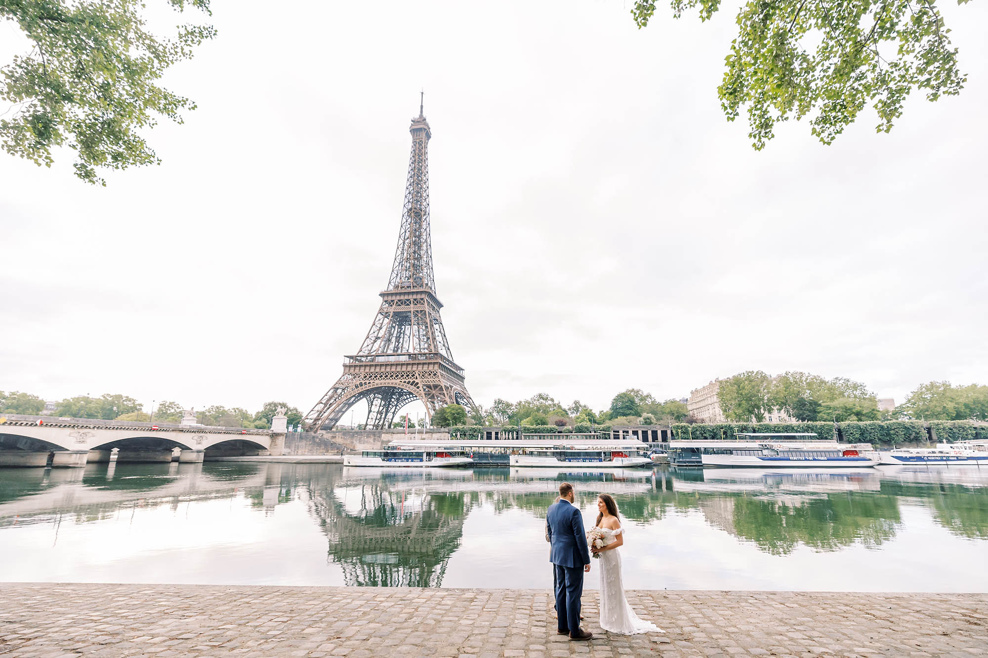couple exchanging vows during their elopement in paris along the seine in front of the eiffel tower, paris wedding photographer