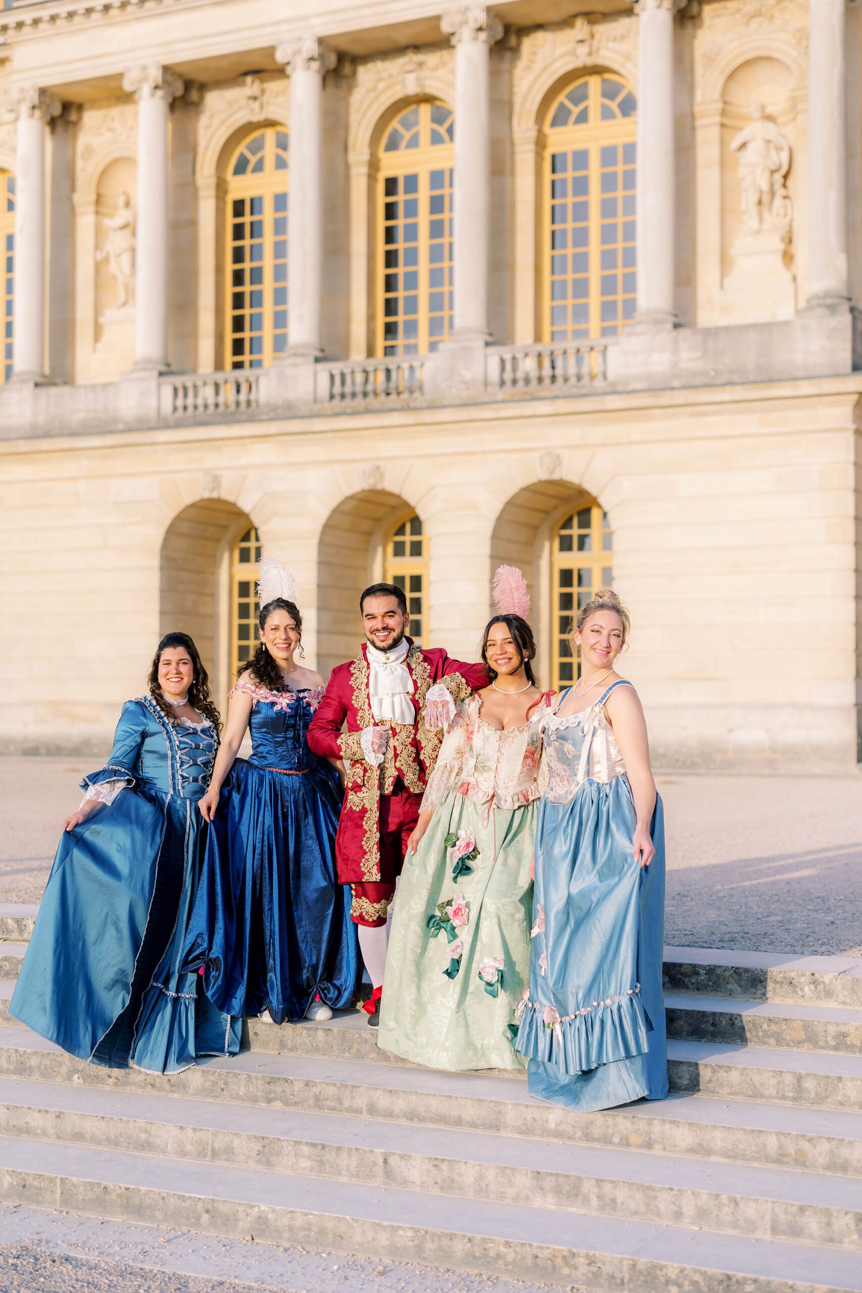 Opulent costumed attendees posing at the 2025 Versailles Grand Masked Ball, captured by L'amour de Paris photographers