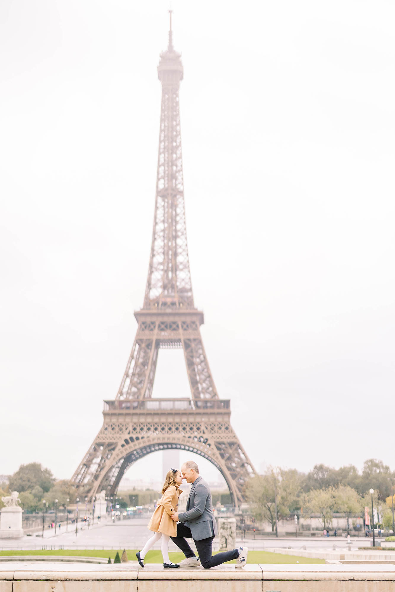 sweet moment with a father and daughter during a family portrait session in front of the eiffel tower