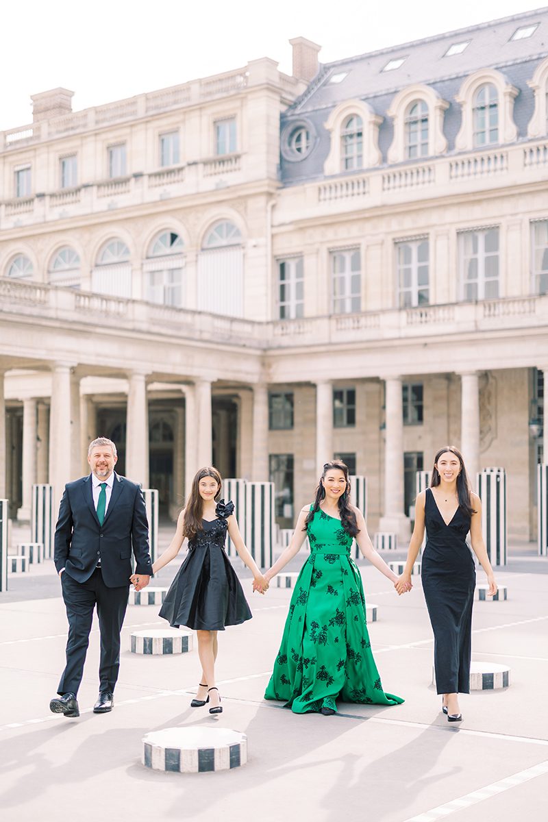 Image for paris photographer review tile - A family of four in formal evening wear posing at Palais Royal. The mother stands out in a stunning emerald green gown against the historic architecture.
