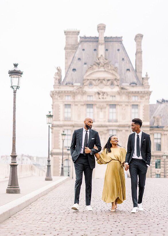 photo for paris photographer review of African American family, mom in gold dress, father and teenage son in black suits, ties, white shirts, and sneakers