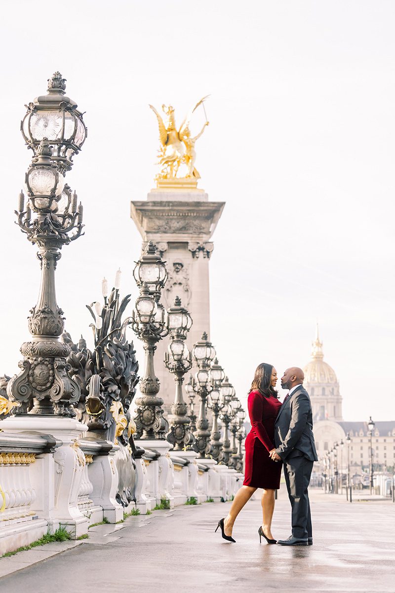 paris photographer review photo of a couple about to kiss on Pont Alexandre III bridge.